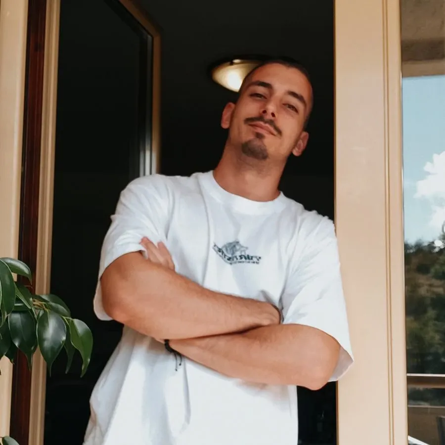 Mihailo, founder of Nothin, arms crossed and smiling